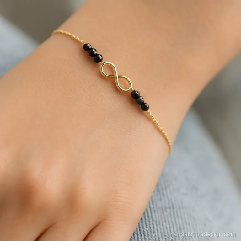 Black beads mangalsutra bracelet on a wrist with a small gold infinity link