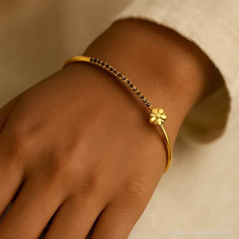 Kada style mangalsutra bracelet on a wrist with black beads on a gold bangle
