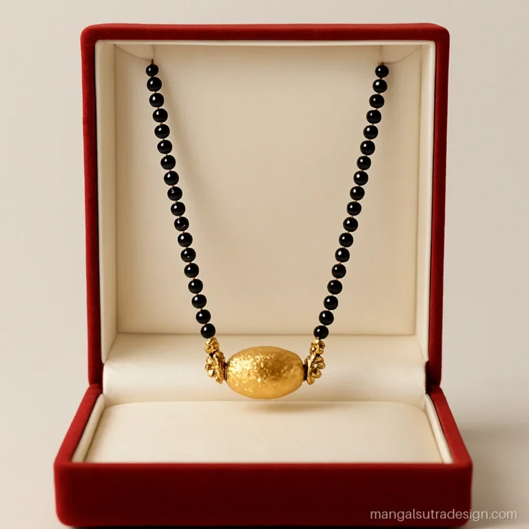 Mani mangalsutra design with a textured oval gold bead and two side caps
