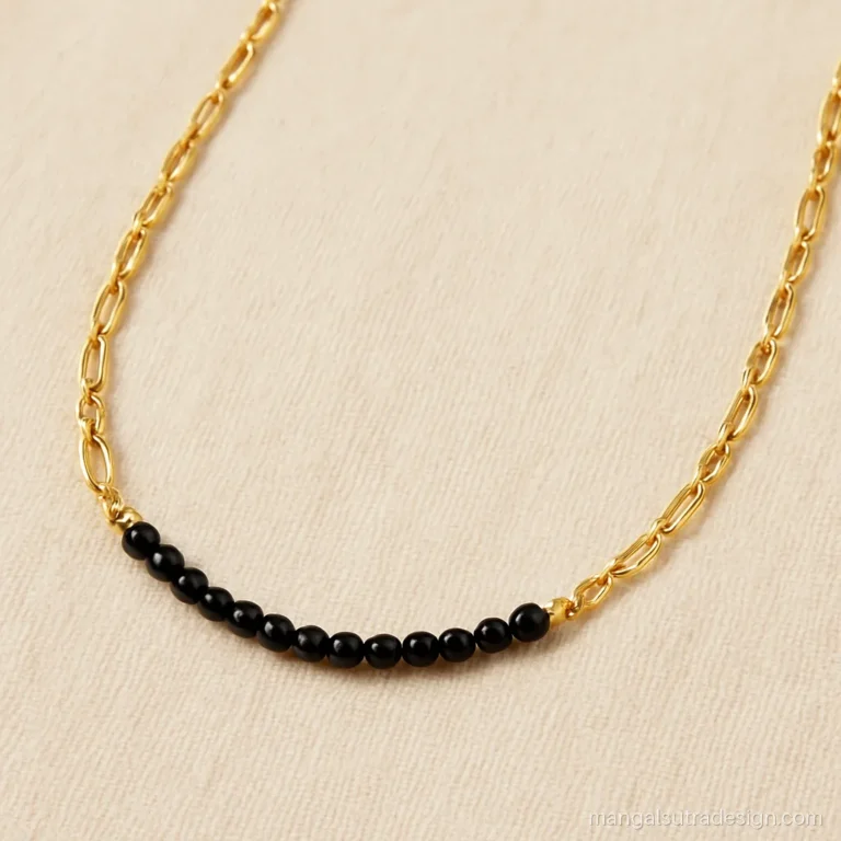 Gold mangalsutra chain design with a figaro chain and a short black bead centre