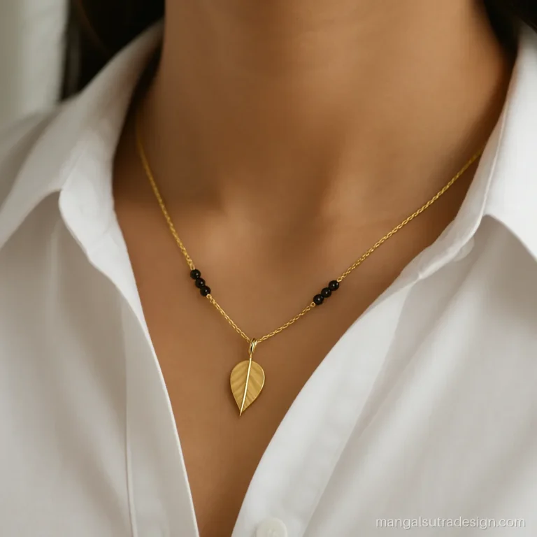 Short gold mangalsutra with small leaf pendant worn with an office shirt collar