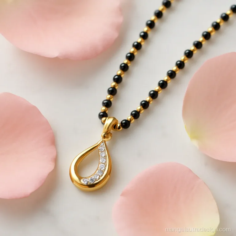 Long mangalsutra design in gold beads and black beads with a diamond drop pendant