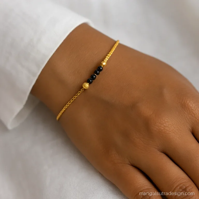 Marathi mangalsutra bracelet on a wrist with two tiny vati and black beads