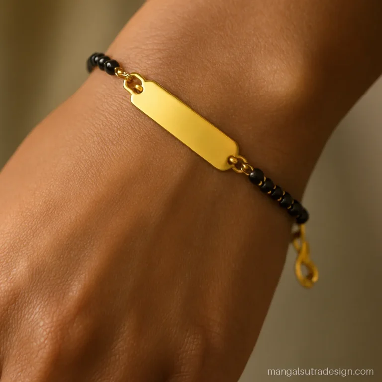 Name mangalsutra bracelet with a curved blank gold plate on black beads at the wrist