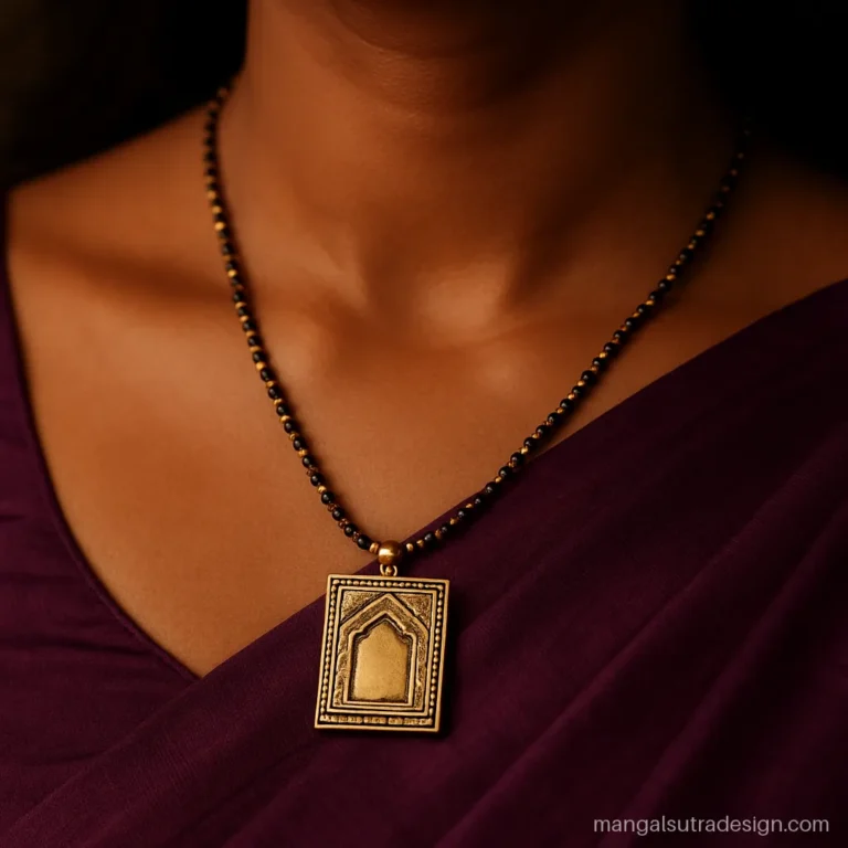 Antique gold mangalsutra locket with a rectangle shape and temple engraving