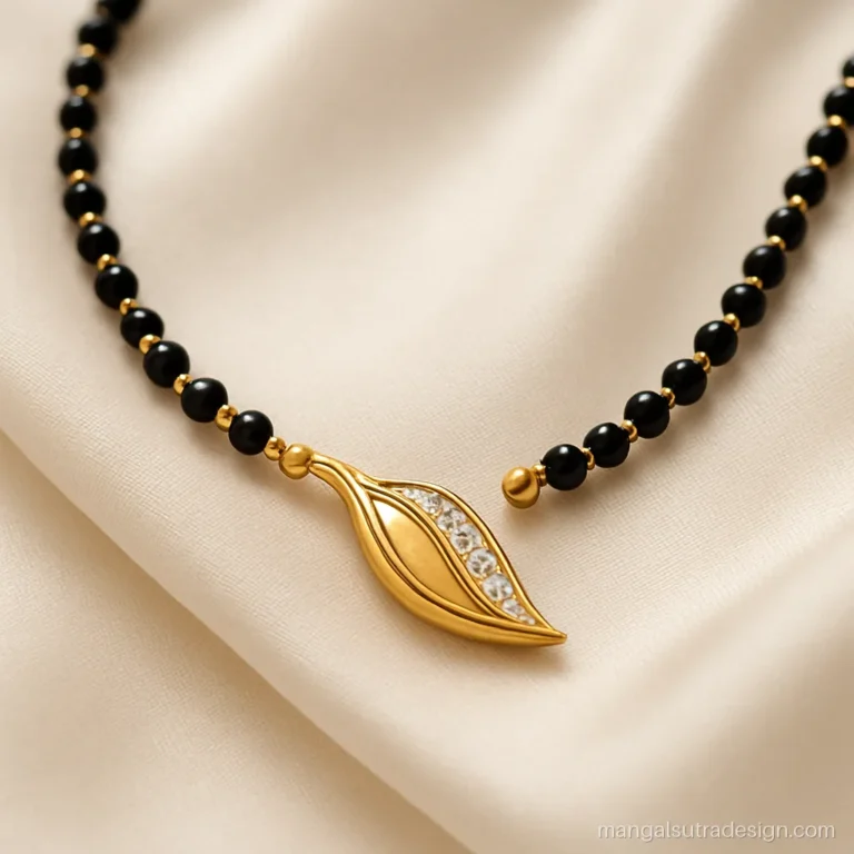 Short mangalsutra design with a fancy gold leaf pendant lined with tiny CZ stones