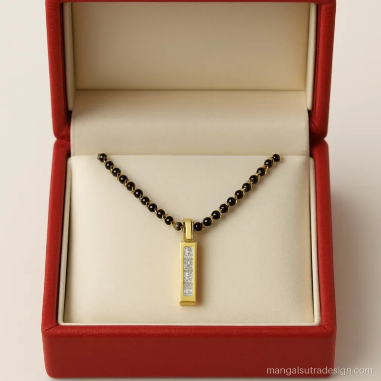 Short modern mangalsutra design with a vertical line of baguette diamonds in a red box