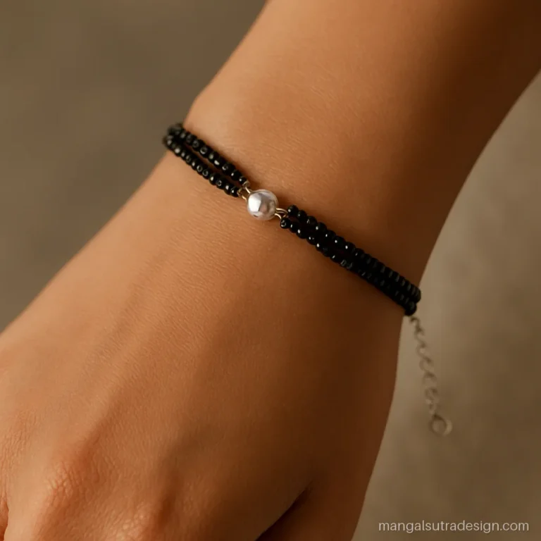 Silver mangalsutra bracelet with two black bead strands and a tiny silver vati