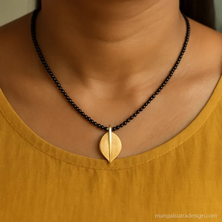 Small daily wear mangalsutra design with a matte gold leaf pendant