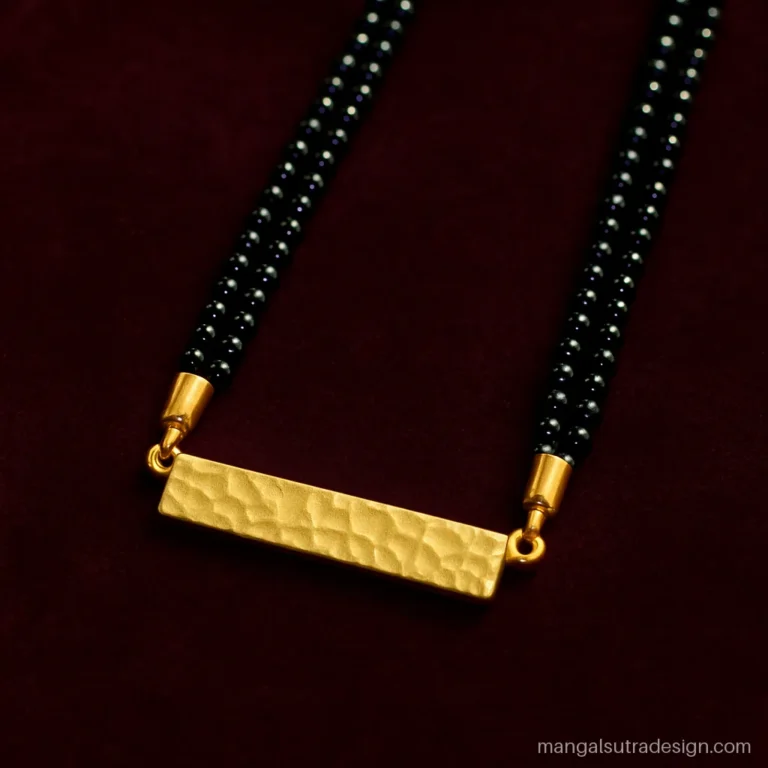 Small gold mangalsutra design with a hammered gold bar on two black bead strands