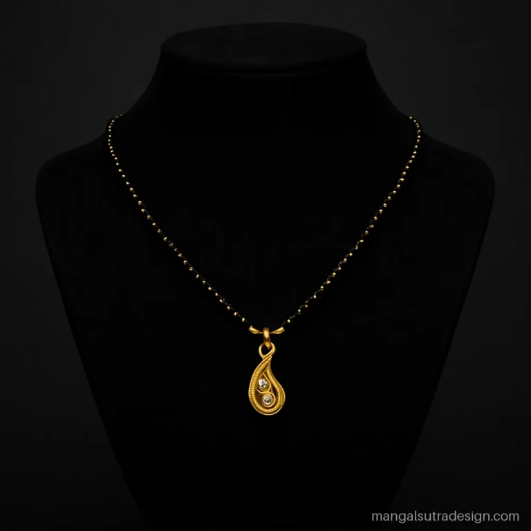 Mini mangalsutra gold design with a small paisley pendant and three white stones